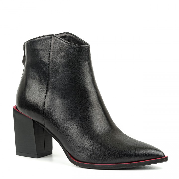 Black leather ankle boots on a wide heel with a red sole