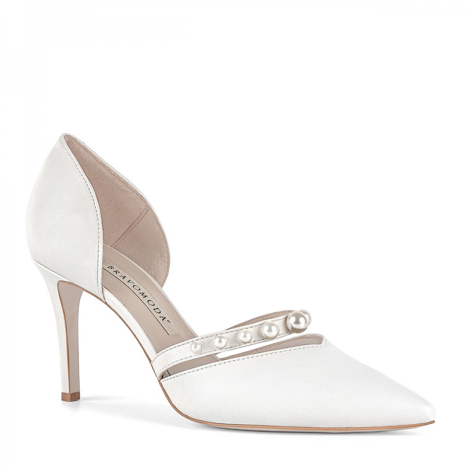 White bridal stiletto pumps with a unique embellishment in the form of a strap adorned with pearls of various sizes