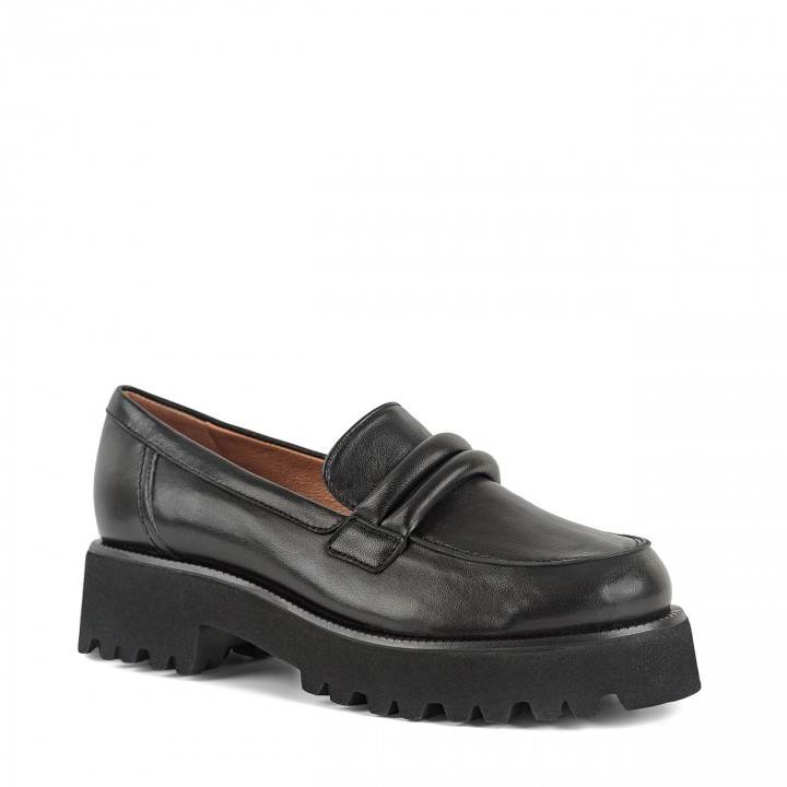 Black moccasins made of genuine grain leather with a high sole