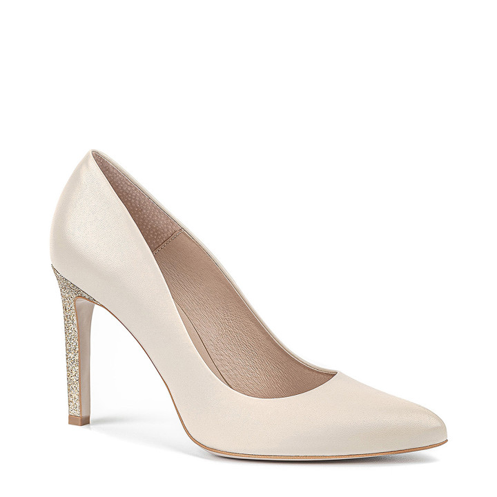 Cream wedding shoes with a high, gold heel