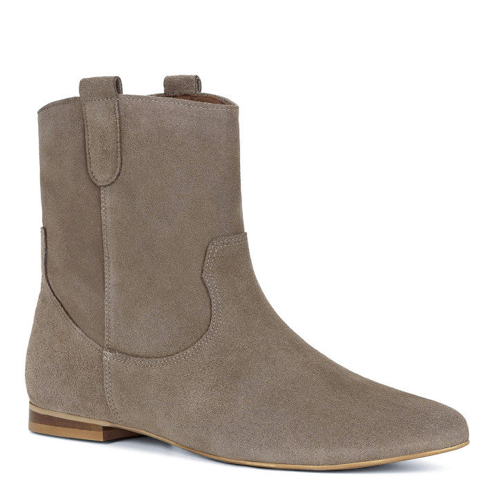 Light-colored slip-on ankle boots made from natural velour leather with a flat heel
