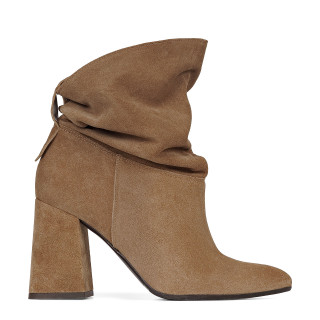 Beige velor ankle boots with a loose upper and a stable heel