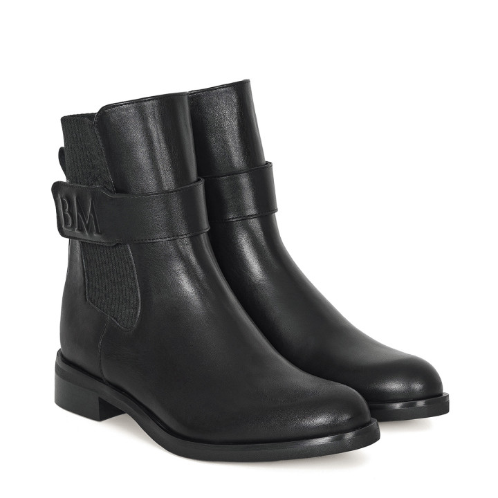 Black leather ankle boots with a flat sole